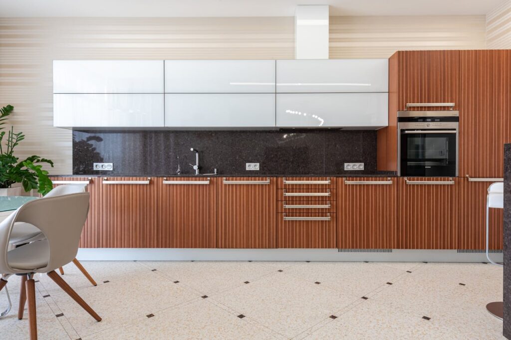 Spacious modern kitchen with elegant wood cabinetry and sleek appliances.