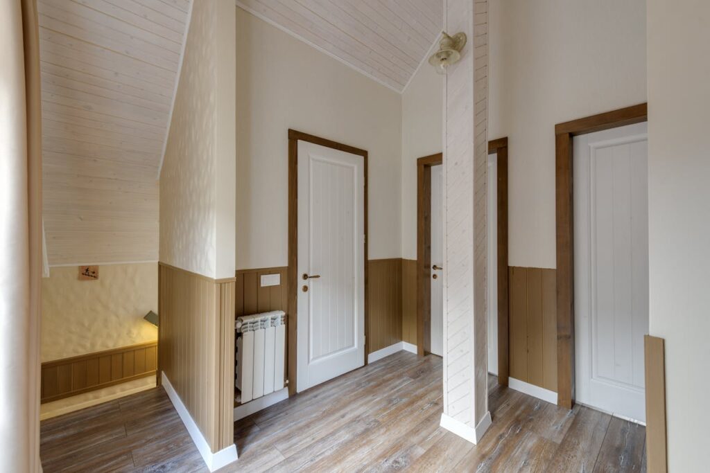 Empty hallway in a modern chalet with wooden doors and elegant design.